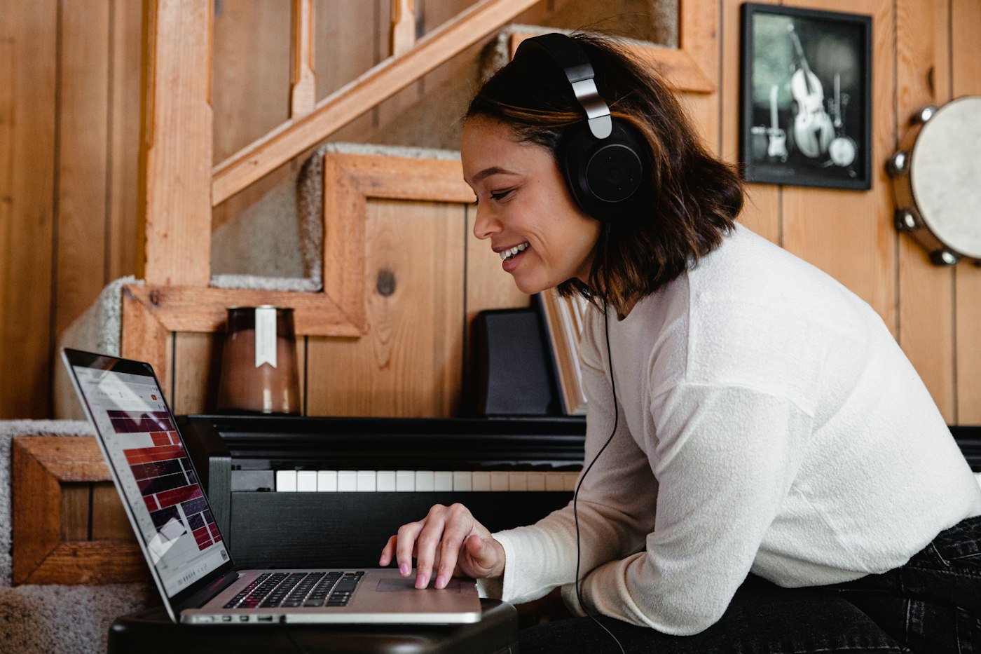 Person in headphones following an online lesson on a laptop