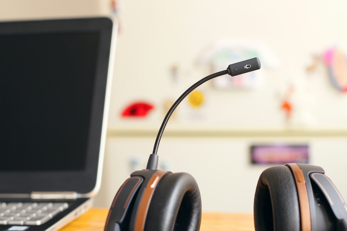 Headset resting beside a laptop, ready to answer calls